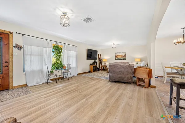 a bedroom with furniture and a wooden floor