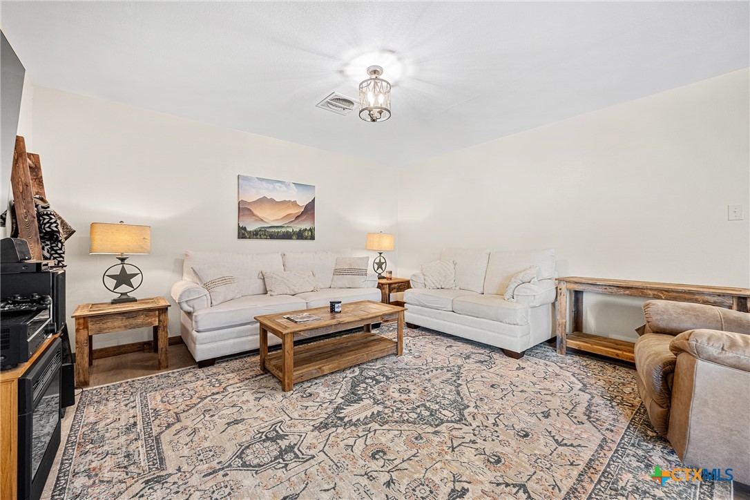 370 County Road 3106 Kempner, TX 76539 - Photo 10 of 34 a living room with furniture and a chandelier