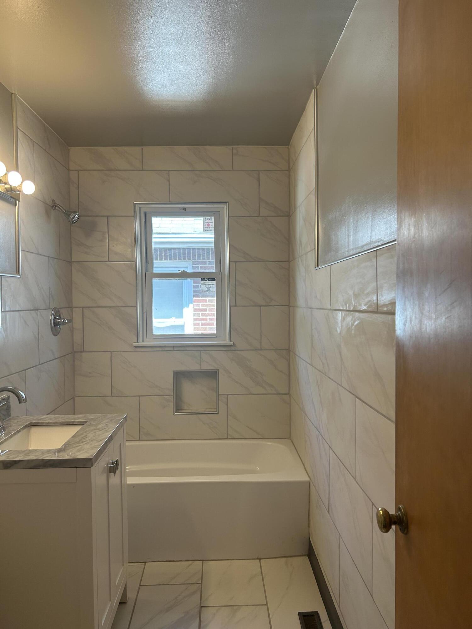 3679 Monroe Street Gary, IN 46408 - Photo 12 of 23 a bathroom with a bathtub and shower
