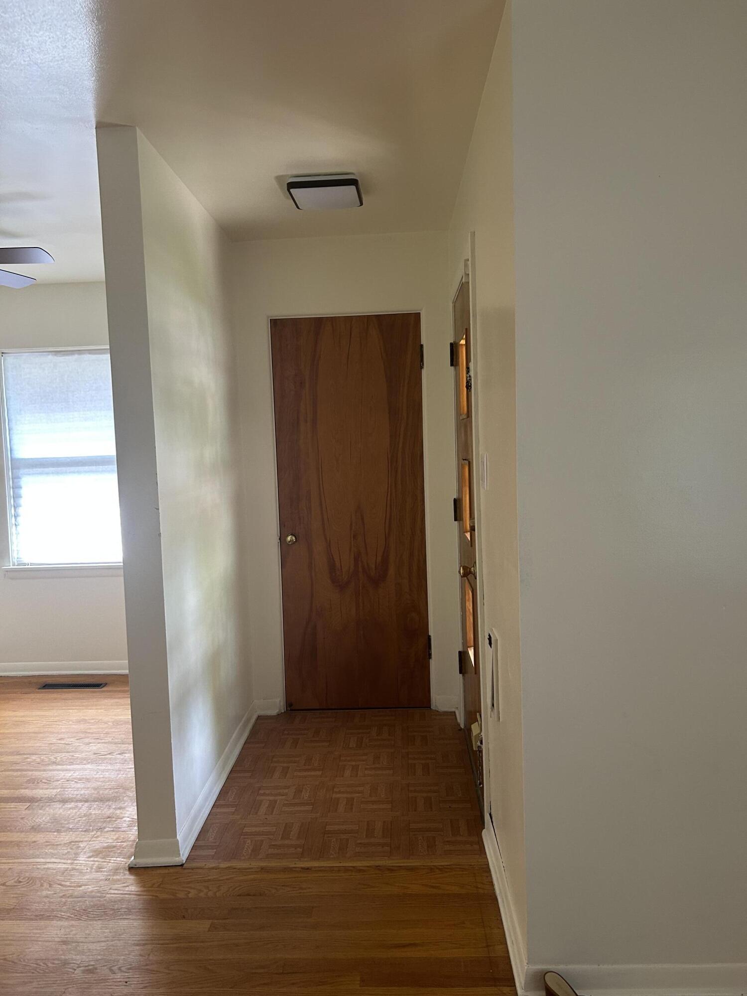 3679 Monroe Street Gary, IN 46408 - Photo 3 of 23 an empty room with wooden floor and entrance