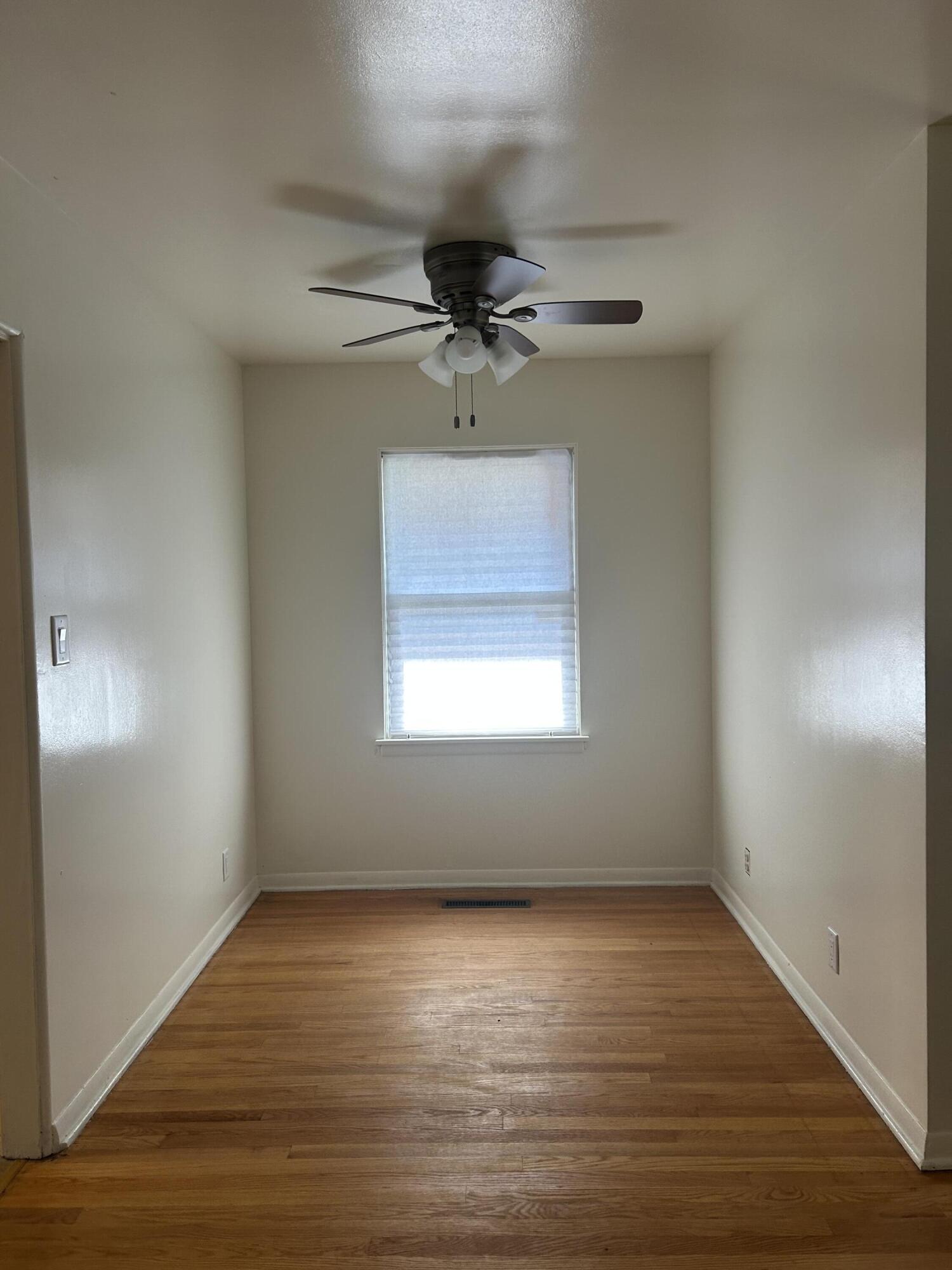 3679 Monroe Street Gary, IN 46408 - Photo 4 of 23 an empty room with a window and a ceiling fan