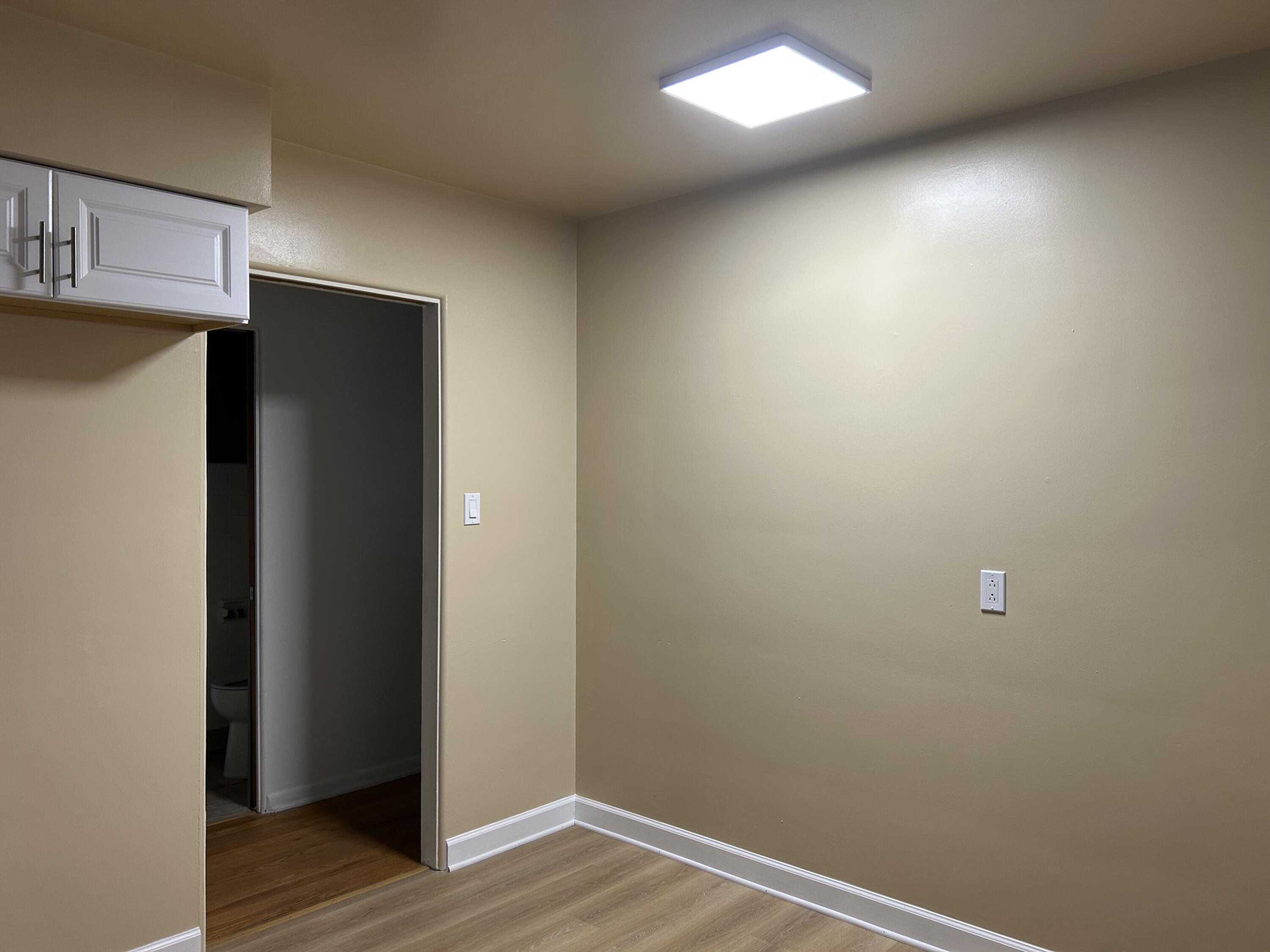 3679 Monroe Street Gary, IN 46408 - Photo 9 of 23 a view of an empty room with wooden floor and closet