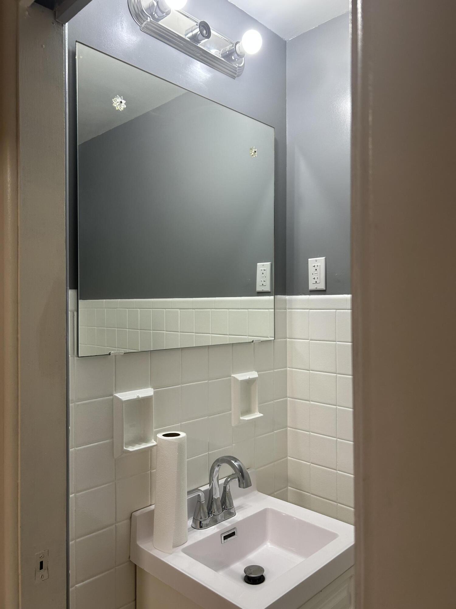 3679 Monroe Street Gary, IN 46408 - Photo 10 of 23 a bathroom with a sink and a mirror