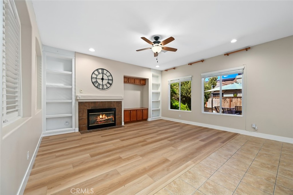 26764 Kingwood Road Murrieta, CA 92563 - Photo 11 of 42 a view of an empty room with a fireplace and a window