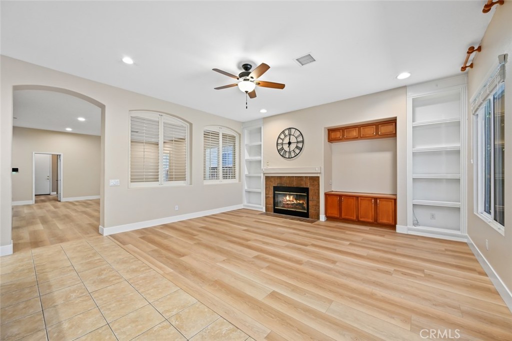 26764 Kingwood Road Murrieta, CA 92563 - Photo 13 of 42 a view of an empty room with a window and fireplace