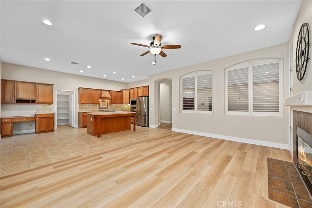 26764 Kingwood Road Murrieta, CA 92563 - Photo 20 of 42 a living room with stainless steel appliances kitchen island granite countertop a stove and a sink