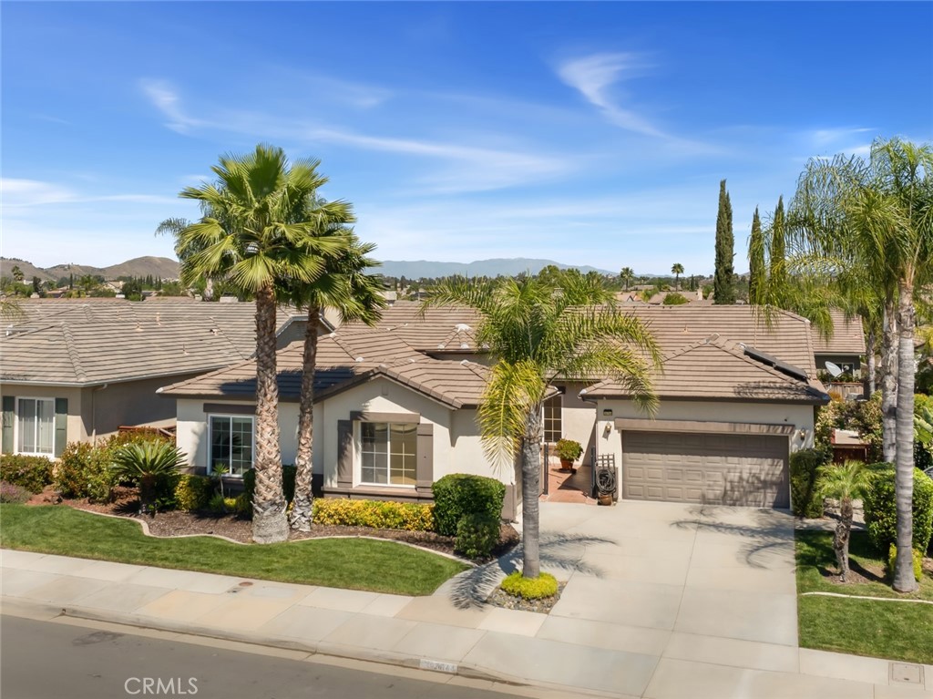26764 Kingwood Road Murrieta, CA 92563 - Photo 2 of 42 a front view of a house with a yard