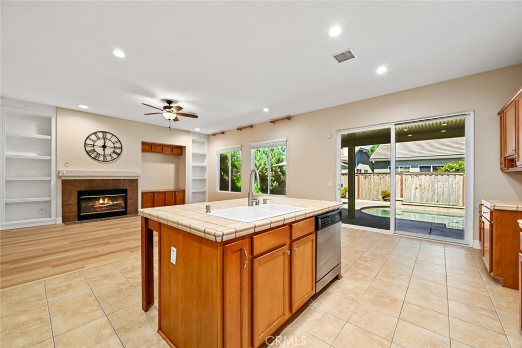 26764 Kingwood Road Murrieta, CA 92563 - Photo 21 of 42 a kitchen with kitchen island granite countertop a stove and a sink