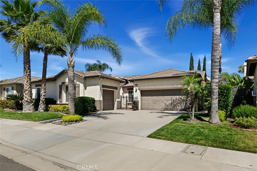 26764 Kingwood Road Murrieta, CA 92563 - Photo 3 of 42 a front view of a house with garden