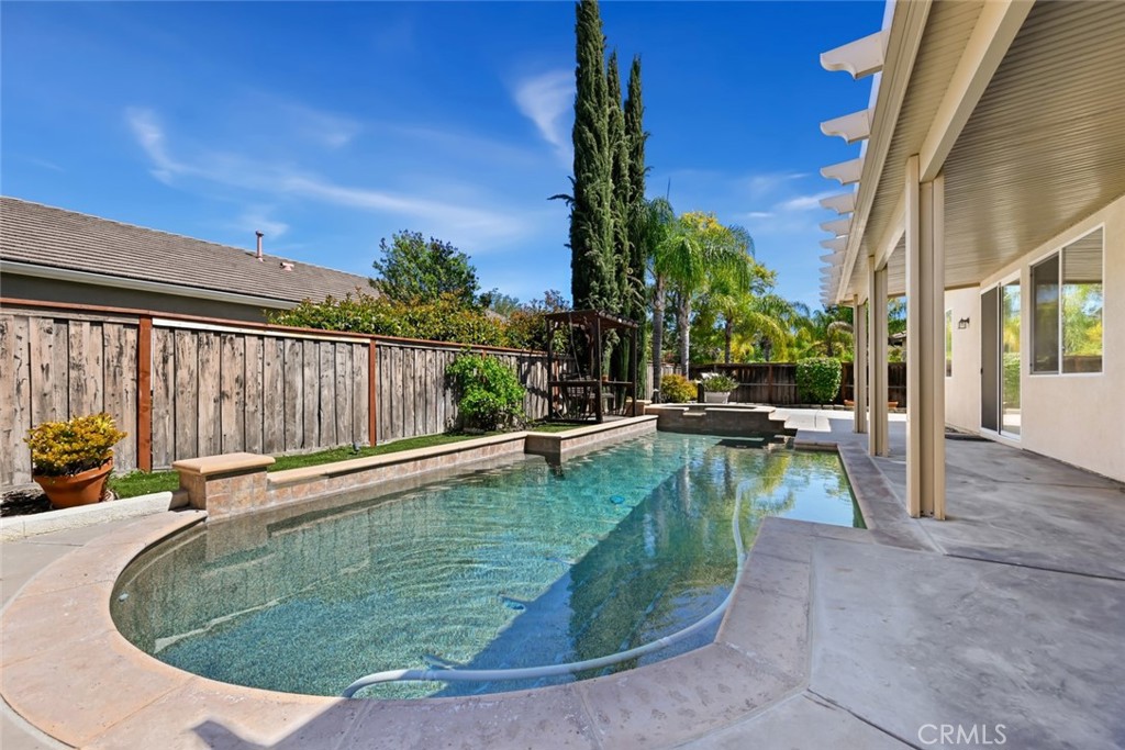 26764 Kingwood Road Murrieta, CA 92563 - Photo 35 of 42 a view of a swimming pool with a patio