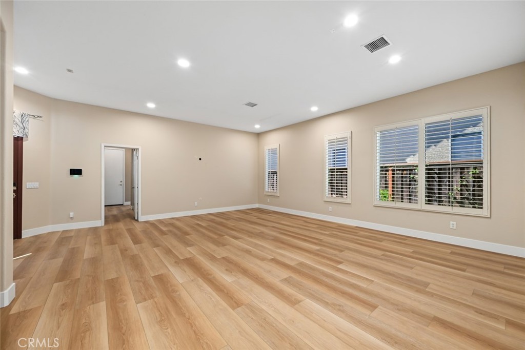 26764 Kingwood Road Murrieta, CA 92563 - Photo 6 of 42 a view of an empty room with wooden floor and a window