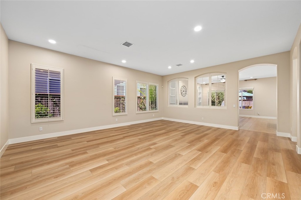 26764 Kingwood Road Murrieta, CA 92563 - Photo 8 of 42 a view of an empty room with wooden floor and a window