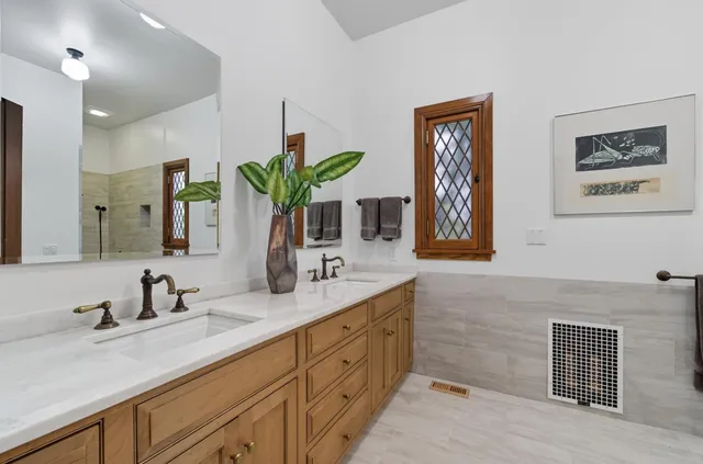 a bedroom with a large bed and a window