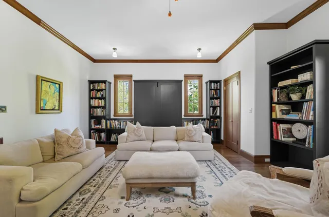 a living room with furniture a rug and a window