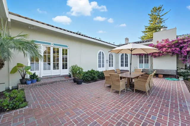 a view of a house with swimming pool and sitting area