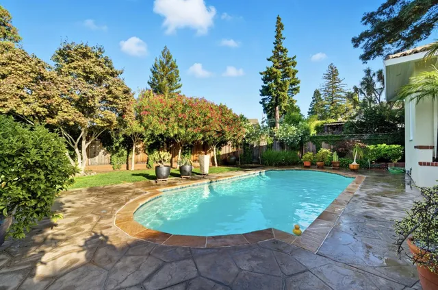 a front view of a house with garden and patio