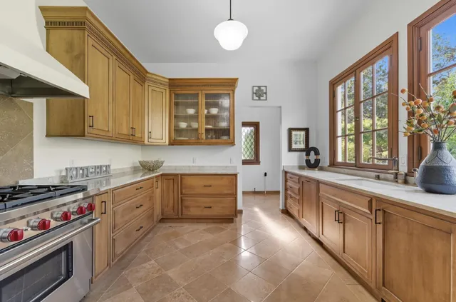 a kitchen with stainless steel appliances a stove sink and cabinets
