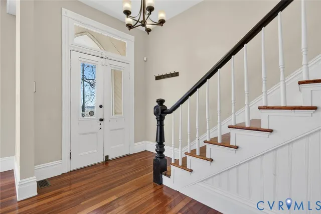 a view of entryway and hall with wooden floor