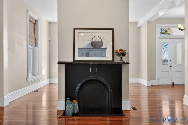 a living room with a fireplace and a wooden floor
