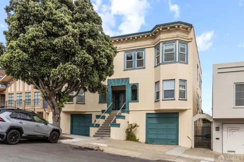 a front view of a residential apartment building with a yard
