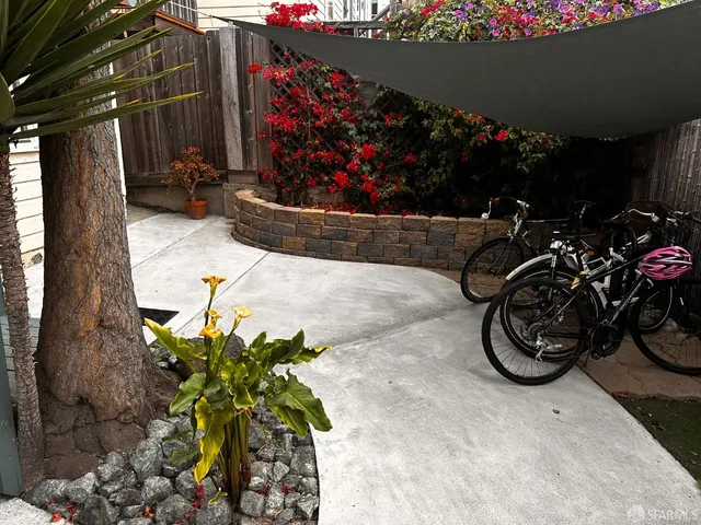 a view of a street with flower pots