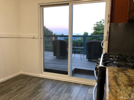 a view of a floor to ceiling window with wooden floor