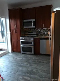 a kitchen with stainless steel appliances and wooden cabinets