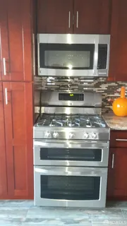 a stove top oven sitting inside of a kitchen