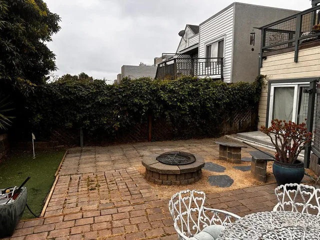 a view of a patio with table and chairs and potted plants
