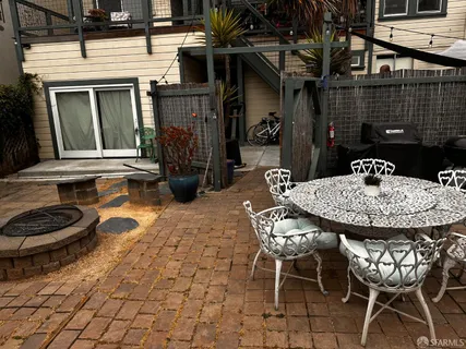 a view of a dinning table and chairs in the patio