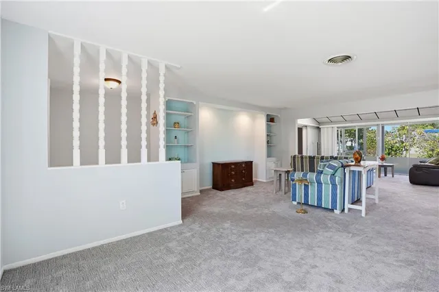 a view of a livingroom with furniture and floor to ceiling window