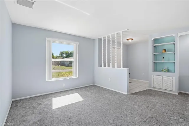 a view of a livingroom with furniture and white walls