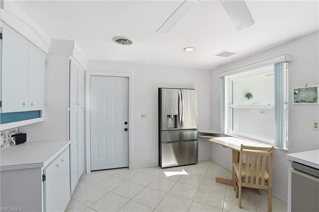 30 Maui Circle, Unit 30 Naples, FL 34112 - Photo 18 of 50 a kitchen with white cabinets and refrigerator