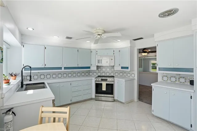a view of a kitchen with refrigerator and cabinets