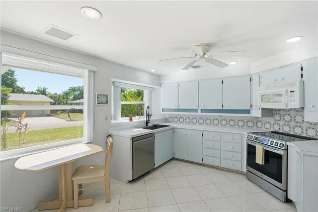 a kitchen with a stove oven and white cabinets