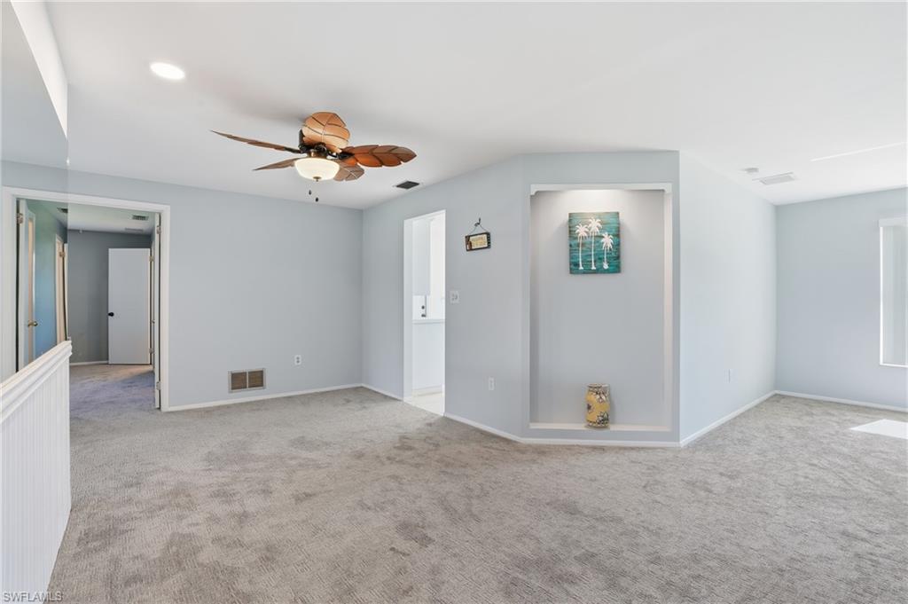 30 Maui Circle, Unit 30 Naples, FL 34112 - Photo 23 of 50 an empty room with closet and a chandelier fan