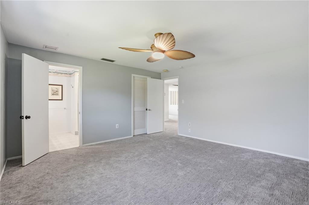 30 Maui Circle, Unit 30 Naples, FL 34112 - Photo 31 of 50 a view of an empty room and chandelier fan