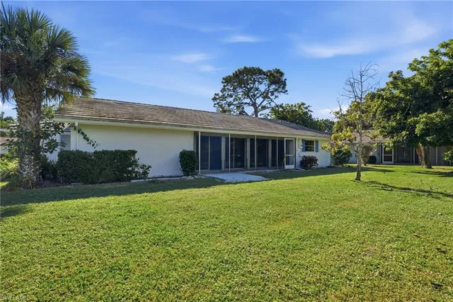 a view of a house with a backyard