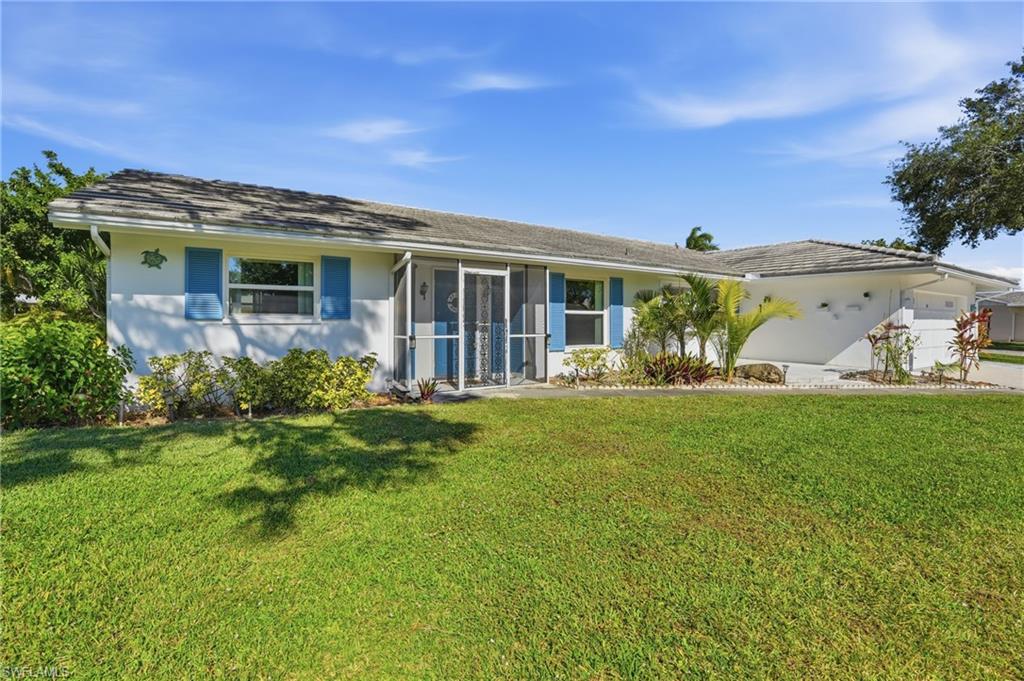 30 Maui Circle, Unit 30 Naples, FL 34112 - Photo 6 of 50 a front view of a house with garden