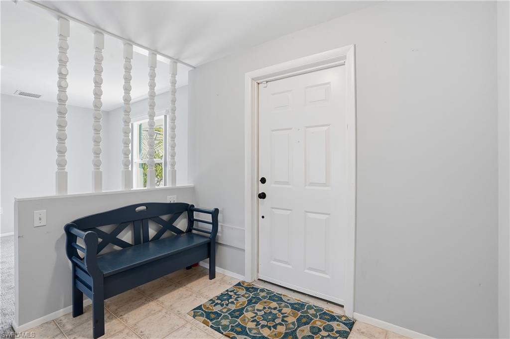 30 Maui Circle, Unit 30 Naples, FL 34112 - Photo 8 of 50 a bedroom with a bed and a window