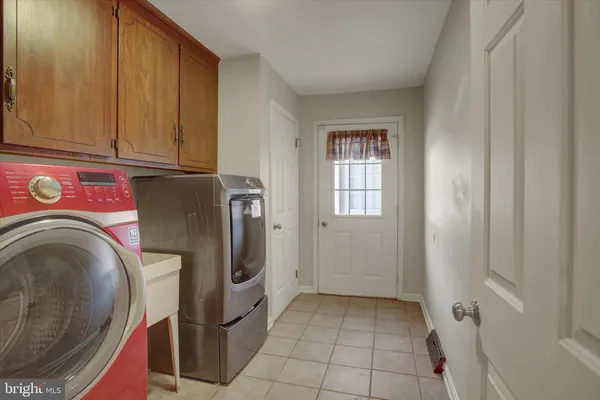 a kitchen with stainless steel appliances granite countertop a sink and a refrigerator
