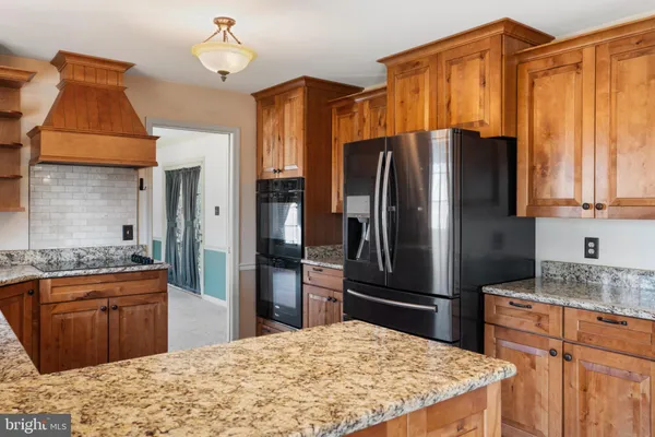 a kitchen with granite countertop a sink and cabinets