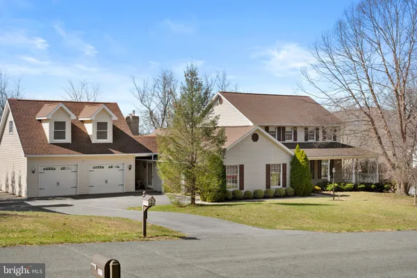 a view of a house with a yard and tree s