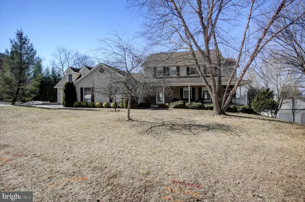 a view of a house with a yard and tree s