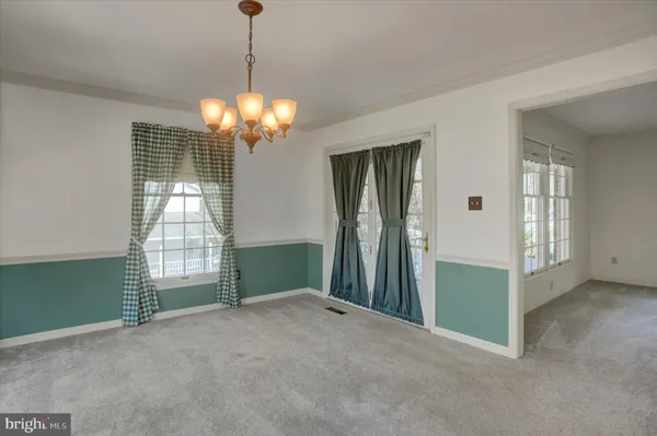an empty room with wooden floor and a ceiling fan