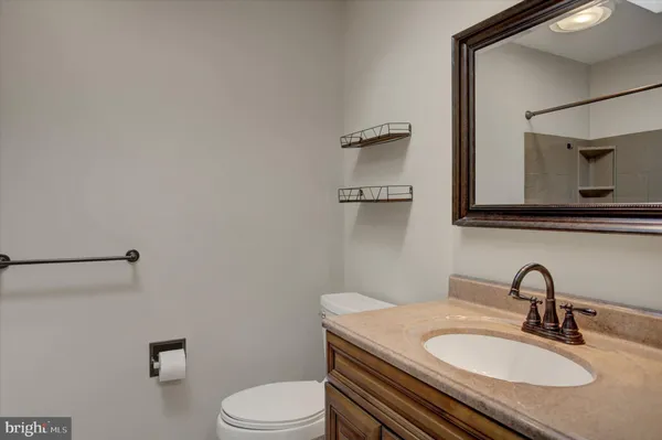 an empty room with wooden floor fireplace and windows