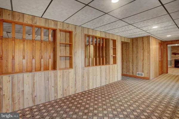 a balcony with wooden floor and city view