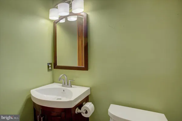 a living room with furniture and a ceiling fan