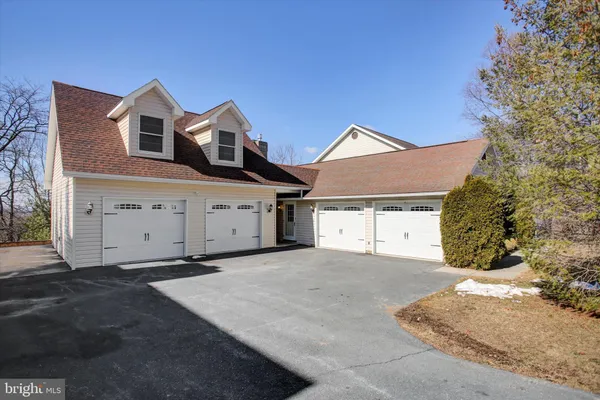 a kitchen with stainless steel appliances kitchen island granite countertop a refrigerator and a sink