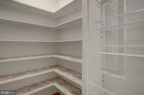 a kitchen with stainless steel appliances kitchen island granite countertop a refrigerator and a sink